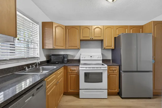 a kitchen with a refrigerator stove and sink