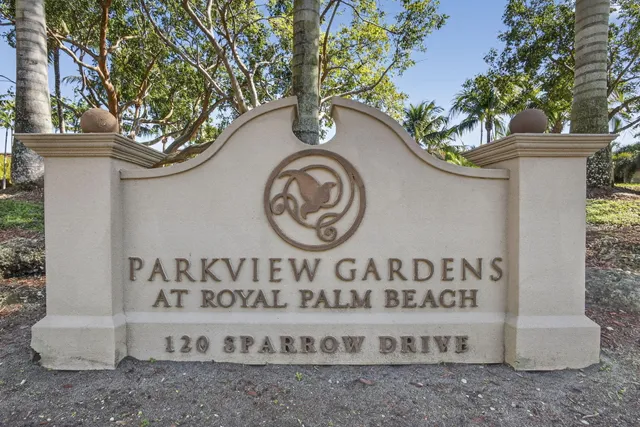 a view of a sign board with a tree