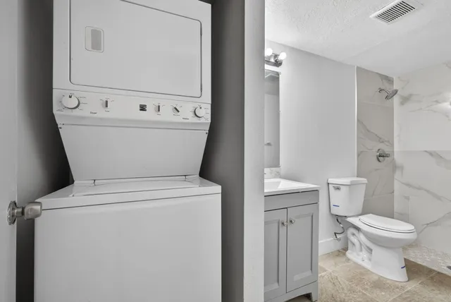 a white toilet sitting next to a bathroom sink