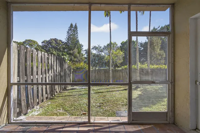 a view of a glass door with a yard