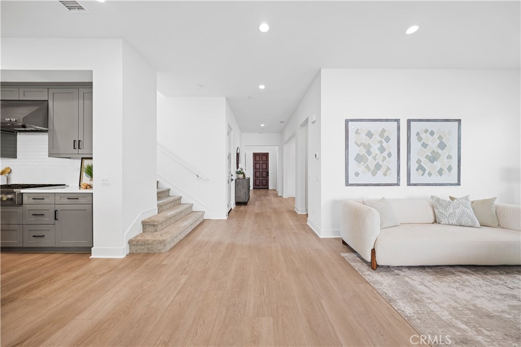 210 Sutters Mill Irvine, CA 92602 - Photo 11 of 46 a living room with furniture and a wooden floor