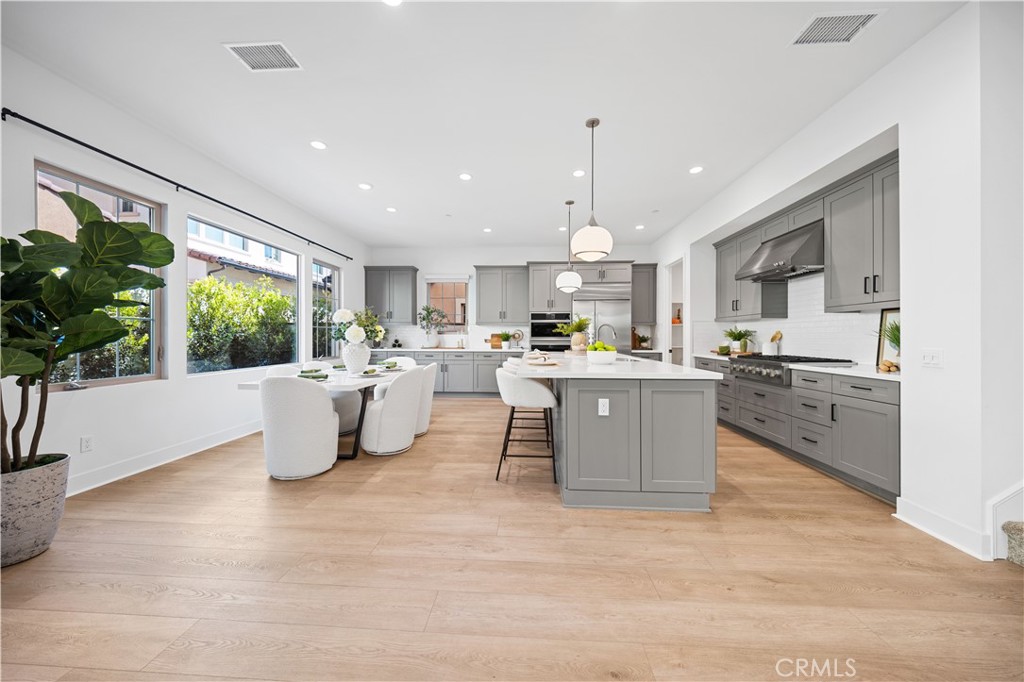 210 Sutters Mill Irvine, CA 92602 - Photo 12 of 46 a living room with stainless steel appliances kitchen island furniture and a large window