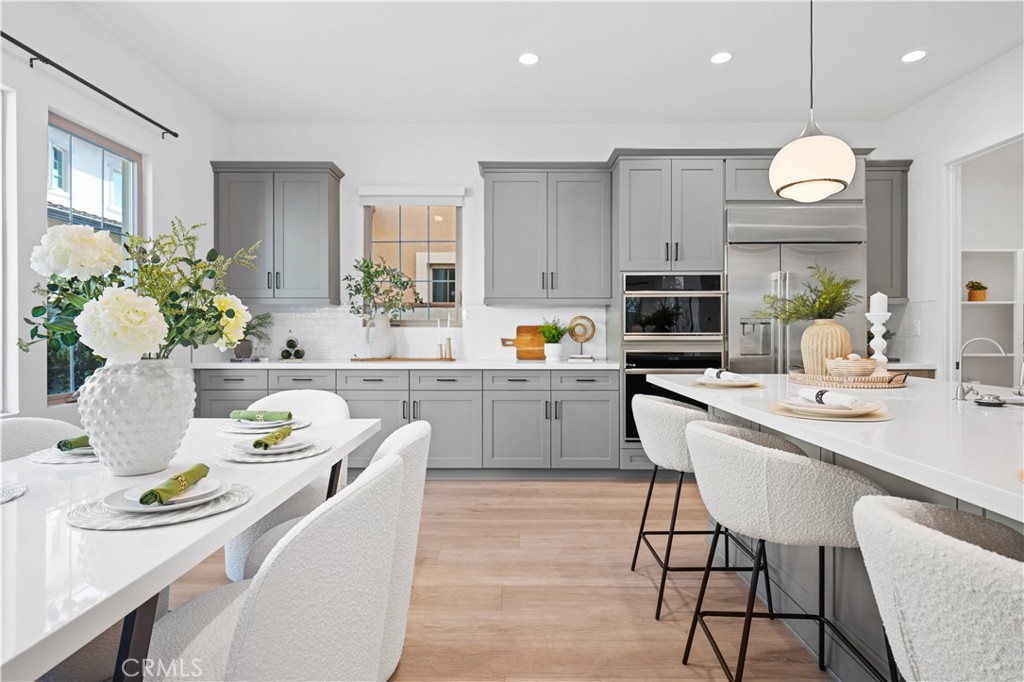 210 Sutters Mill Irvine, CA 92602 - Photo 18 of 46 a kitchen that has cabinets a sink and chairs in it