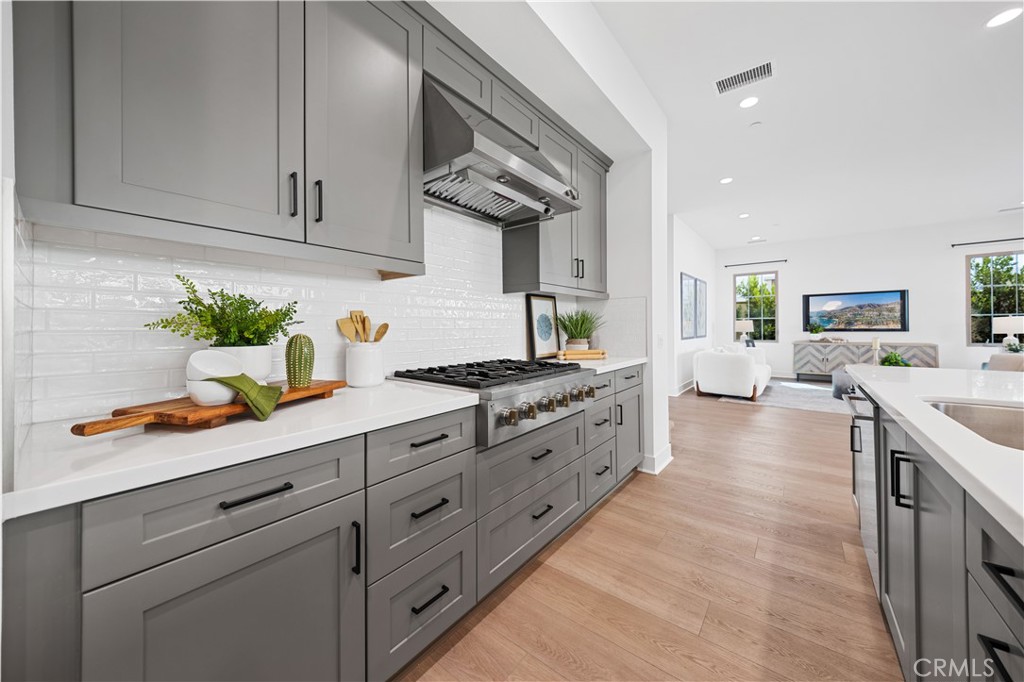210 Sutters Mill Irvine, CA 92602 - Photo 20 of 46 a kitchen with granite countertop white cabinets and stainless steel appliances