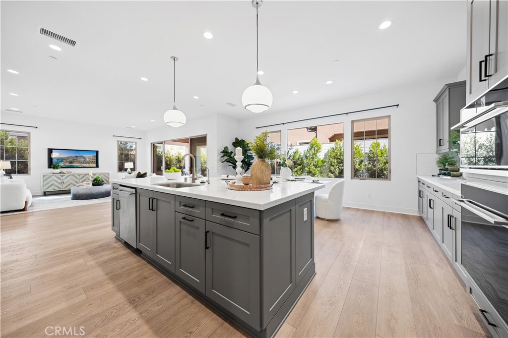 210 Sutters Mill Irvine, CA 92602 - Photo 22 of 46 a kitchen with stainless steel appliances granite countertop a sink and cabinets
