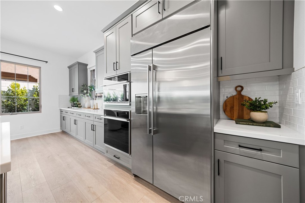 210 Sutters Mill Irvine, CA 92602 - Photo 23 of 46 a kitchen with stainless steel appliances white cabinets and a window