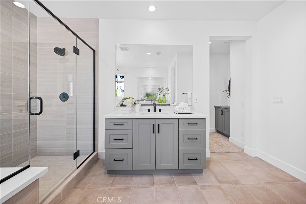 210 Sutters Mill Irvine, CA 92602 - Photo 33 of 46 a bathroom with a shower sink and mirror