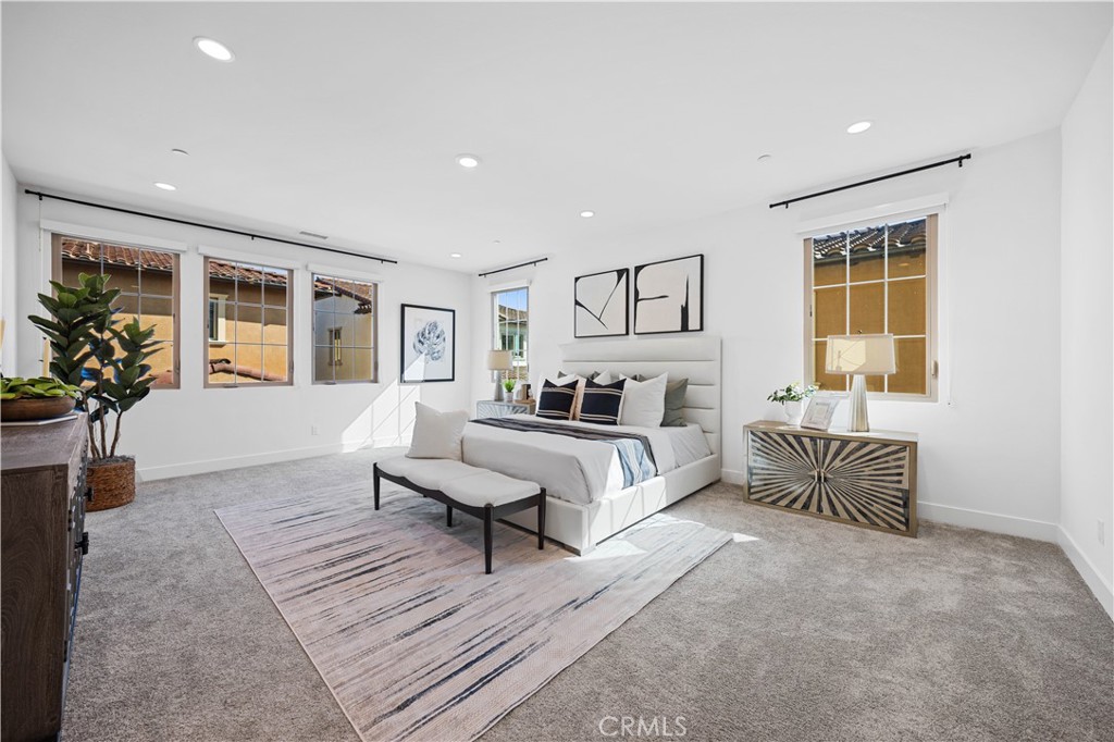 210 Sutters Mill Irvine, CA 92602 - Photo 35 of 46 a spacious bedroom with a bed and a couch