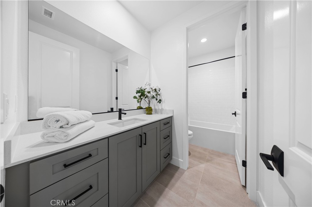 210 Sutters Mill Irvine, CA 92602 - Photo 39 of 46 a bathroom with a granite countertop sink and a mirror