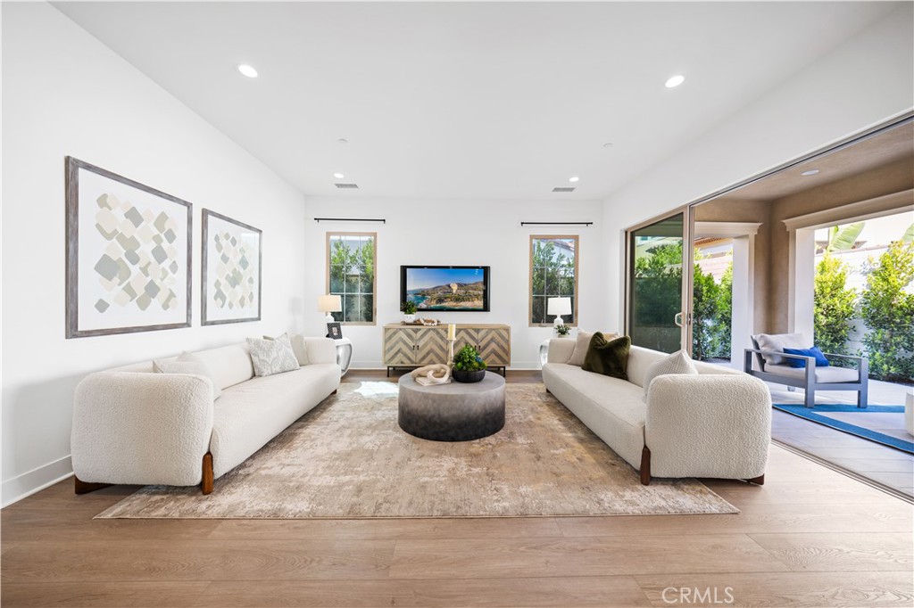 210 Sutters Mill Irvine, CA 92602 - Photo 10 of 46 a living room with furniture potted plant and a large window