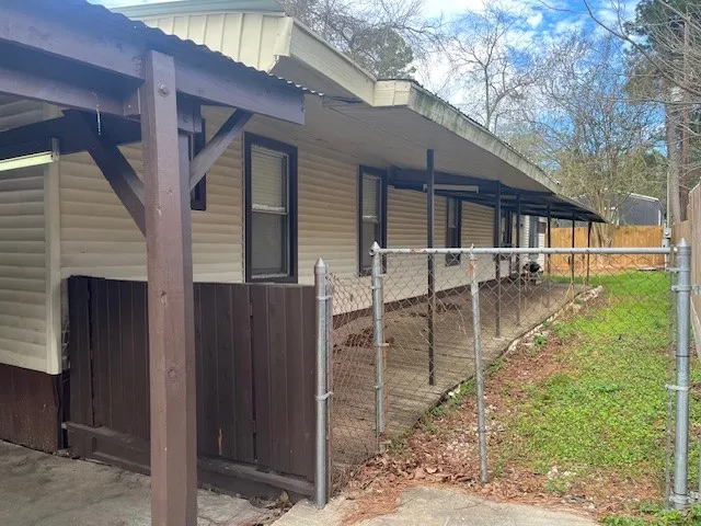 a view of a house with backyard and porch