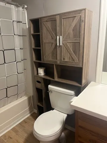 a bathroom with a toilet a sink and shower