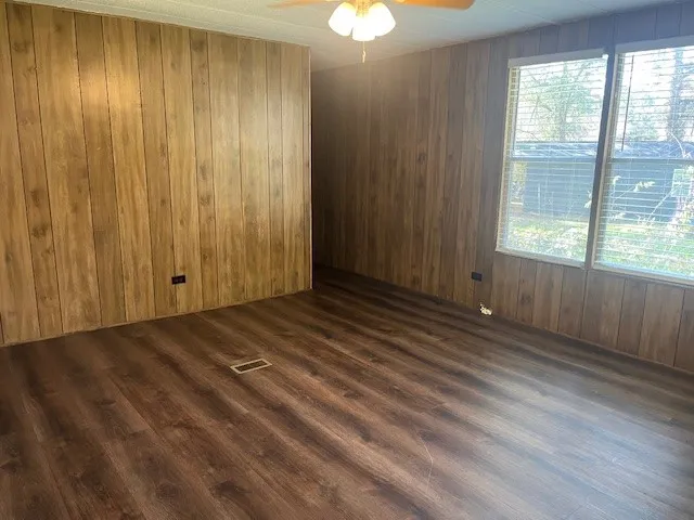 a view of wooden floor and windows in a room