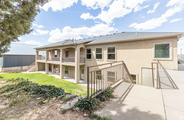 888 East Fiddlers Canyon Road Cedar City, UT 84721 - Photo 63 of 74 Rear view of house featuring stucco siding, a patio, a lawn, and a shingled roof