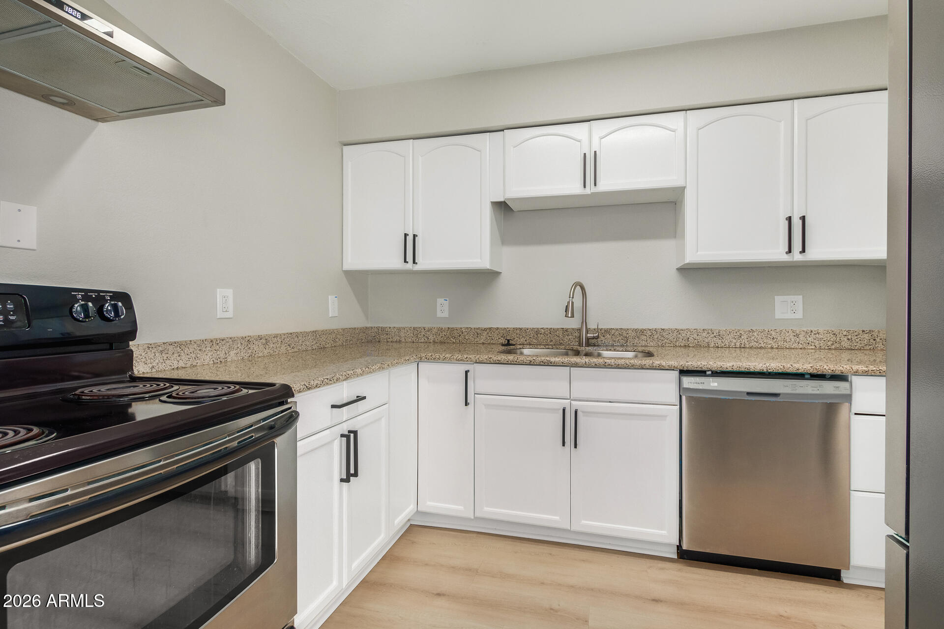 4911 East Culver Street Phoenix, AZ 85008 - Photo 11 of 26 a white kitchen with granite countertop white cabinets and stainless steel appliances