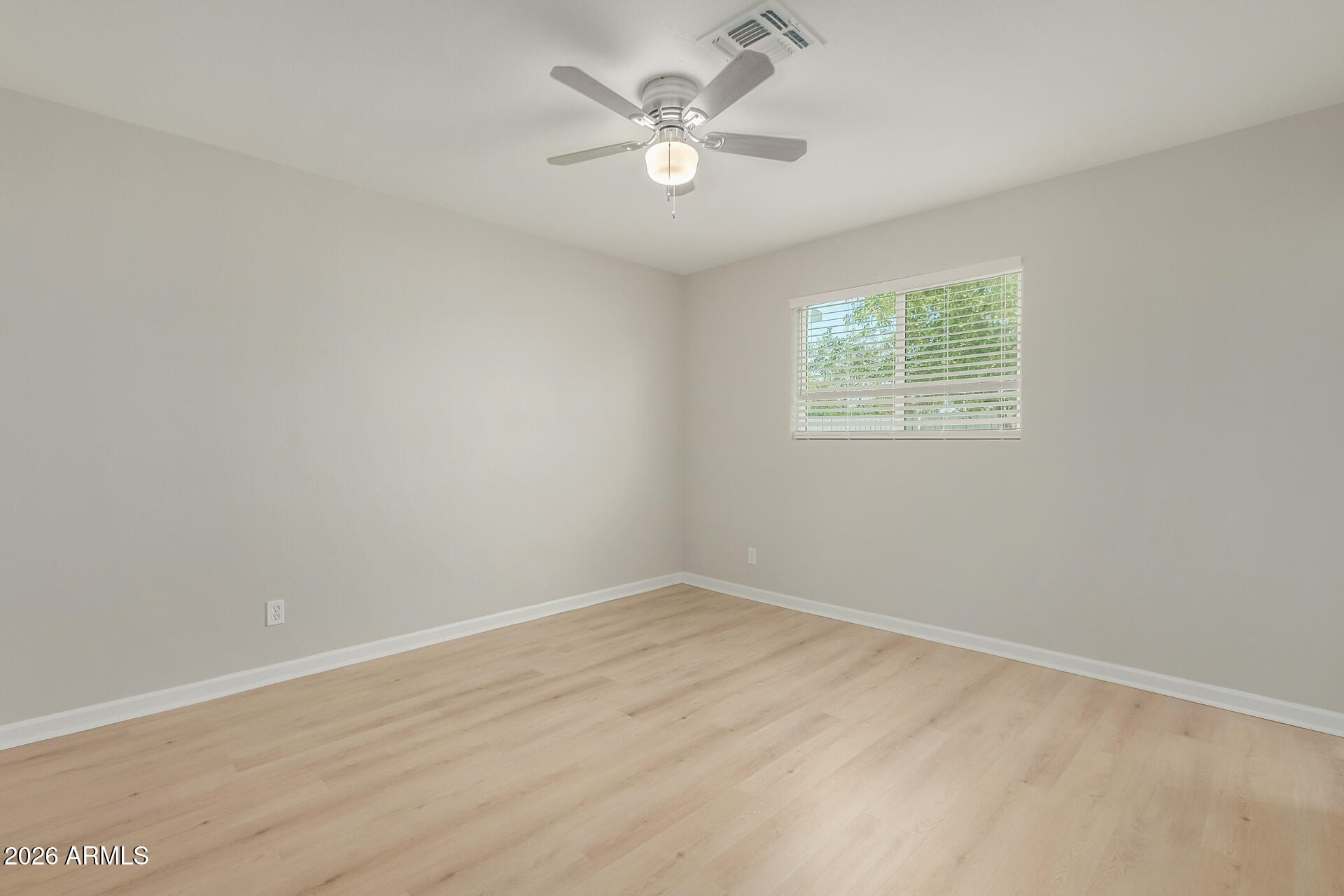 4911 East Culver Street Phoenix, AZ 85008 - Photo 13 of 26 an empty room with a window and a fan