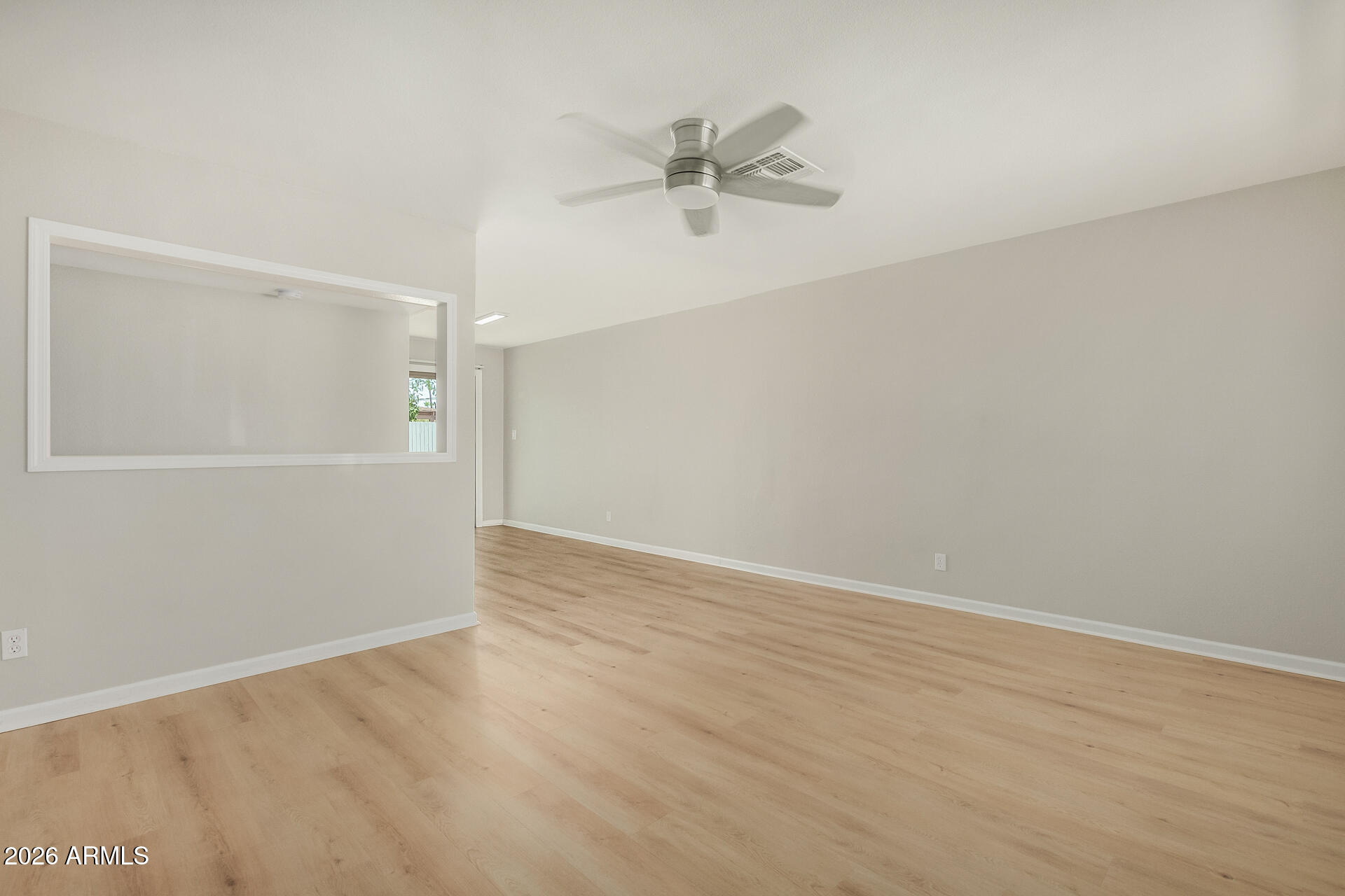 4911 East Culver Street Phoenix, AZ 85008 - Photo 7 of 26 a view of a room with wooden floor and a ceiling fan