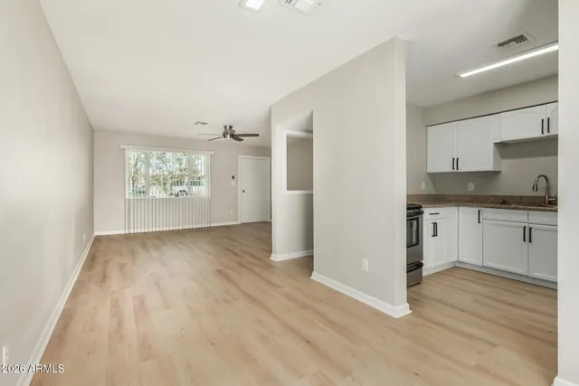 a view of kitchen with granite countertop cabinets and wooden floor