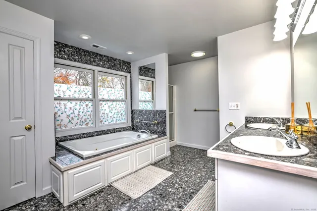 a bathroom with a sink a mirror and a bathtub