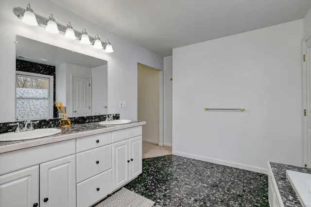 a bathroom with a sink a vanity and a mirror