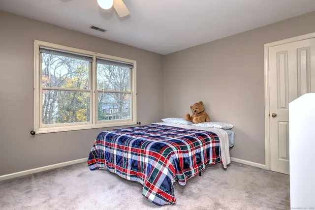a bedroom with a bed and window