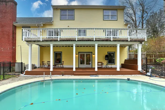 a view of a building with a large window and a yard