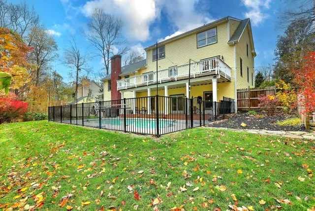 a view of a house with backyard and sitting area