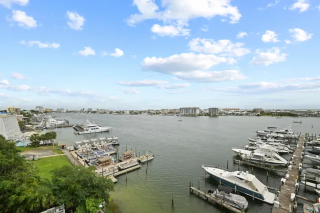 a view of a lake with lawn chairs