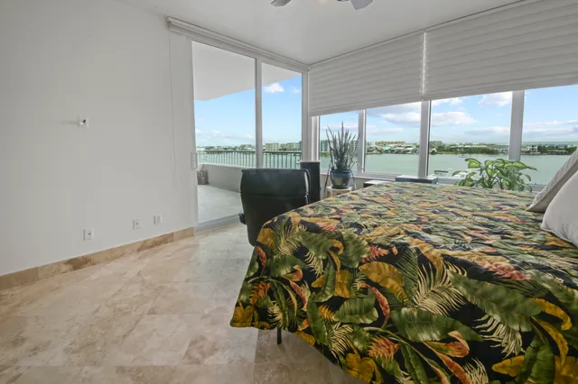 a bed sitting in a bedroom next to a large window