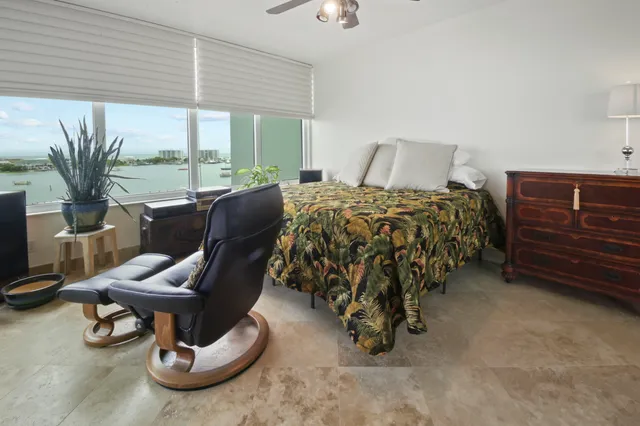 a bedroom with a bed and a chair