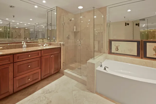 a bathroom with a bathtub shower sink and mirror