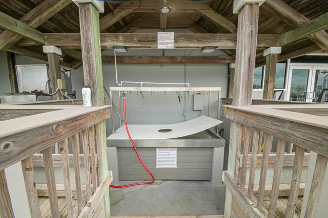 a living room with furniture and a view of kitchen