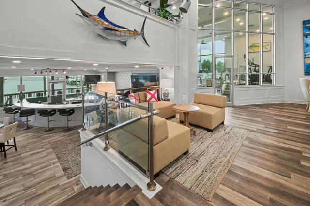 a living room with lots of furniture and a large window