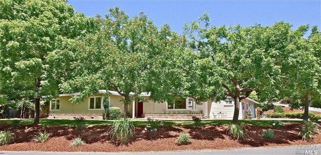 front view of a house with a tree