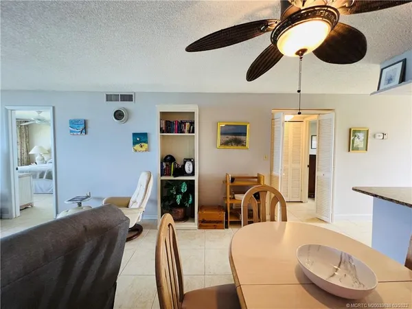 a living room with furniture and kitchen chandelier