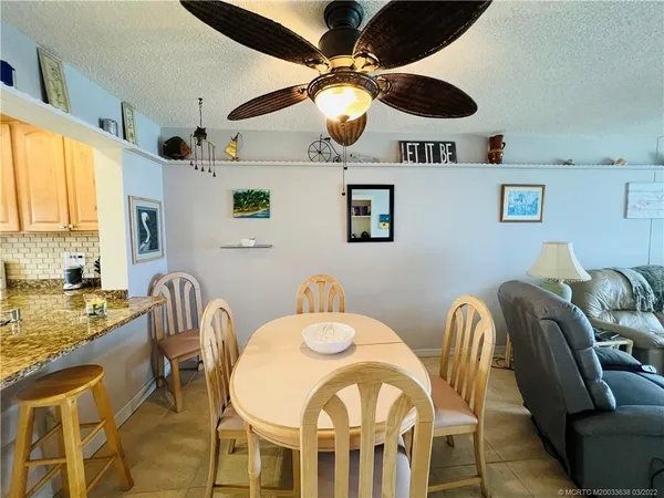 a dining room with furniture and chandelier