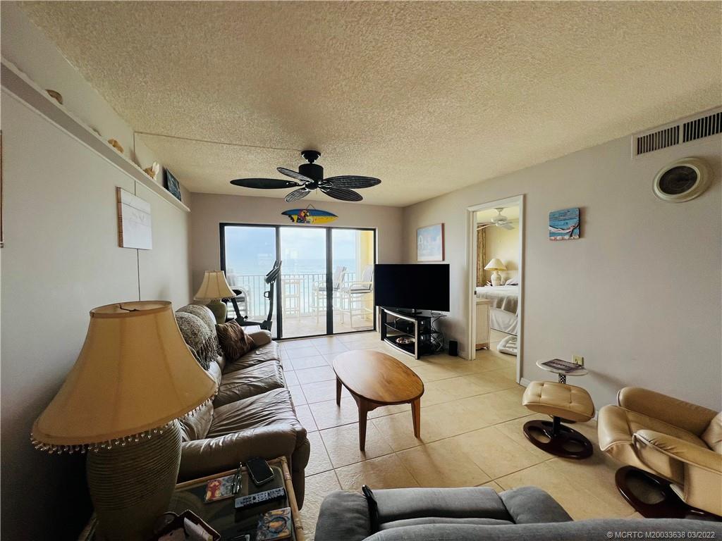 7430 South Ocean Drive, Unit 619B Jensen Beach, FL 34957 - Photo 14 of 57 a living room with furniture a flat screen tv and a window