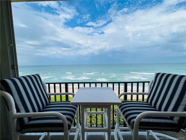 a view of a balcony with a lounge chair