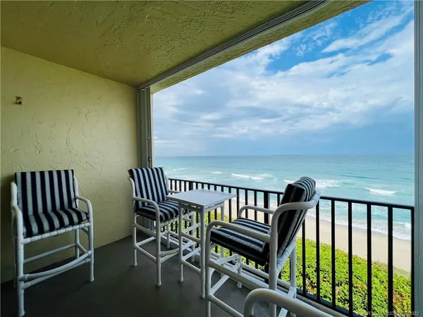 a view of a balcony with chairs