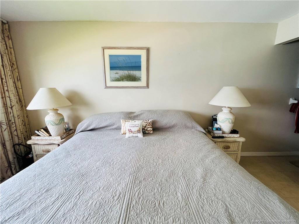 7430 South Ocean Drive, Unit 619B Jensen Beach, FL 34957 - Photo 30 of 57 a bedroom with a bed and a lamp