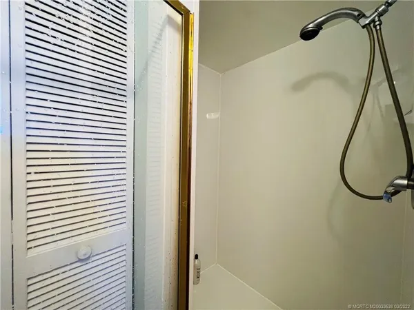 a bathroom with a sink a mirror a toilet and a shower