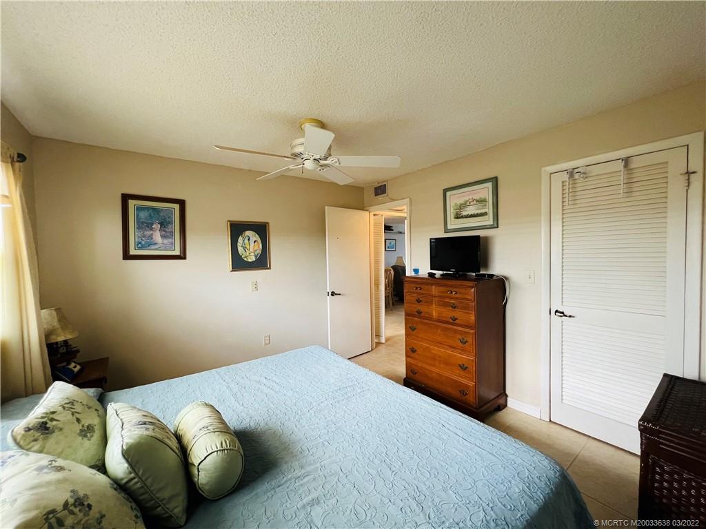 7430 South Ocean Drive, Unit 619B Jensen Beach, FL 34957 - Photo 40 of 57 a bedroom with a bed and wooden floor