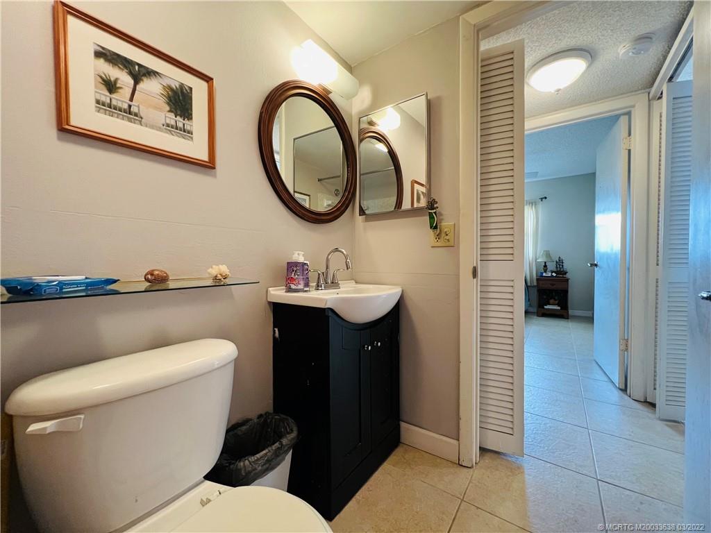 7430 South Ocean Drive, Unit 619B Jensen Beach, FL 34957 - Photo 44 of 57 a bathroom with a toilet a sink and a mirror