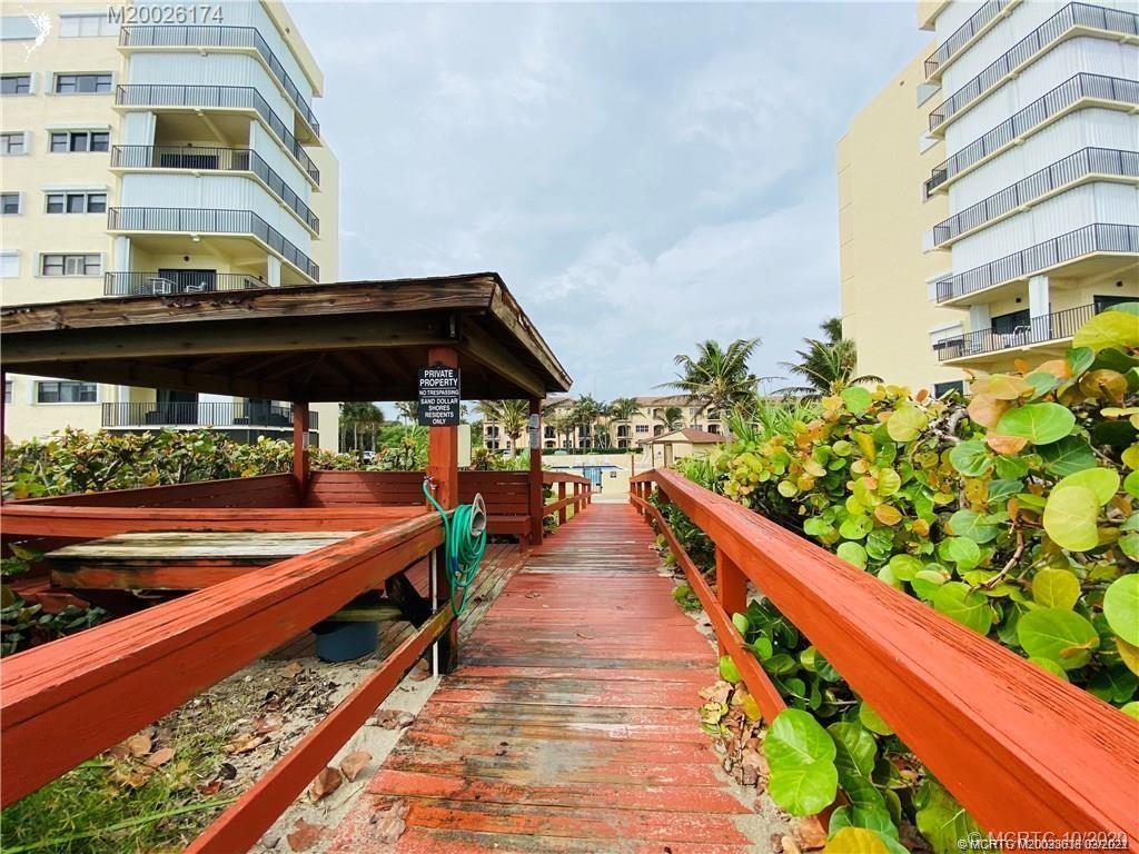 7430 South Ocean Drive, Unit 619B Jensen Beach, FL 34957 - Photo 55 of 57 a group of people sitting on a balcony with wooden floor