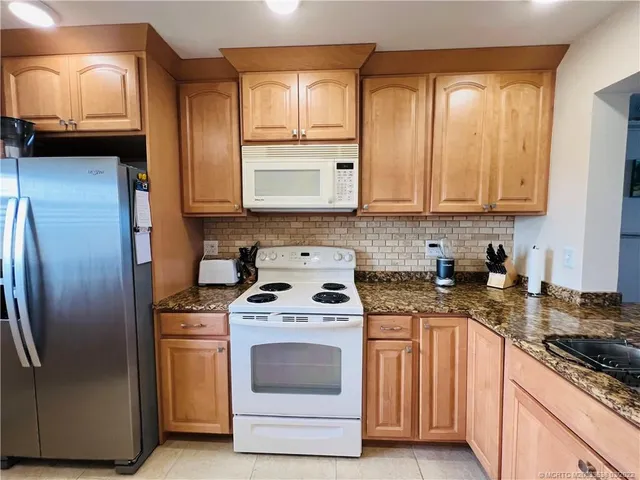 a kitchen with a stove and a refrigerator
