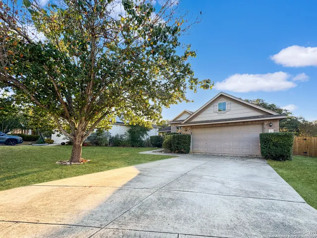a view of a house with a yard and garage