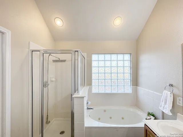 a bathroom with a bathtub and a shower