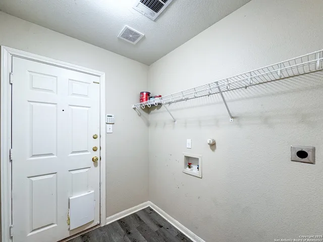 a view of a storage & utility room with racks on the wall