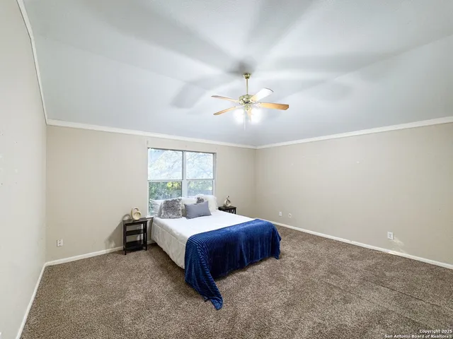 a bedroom with a bed and chandelier