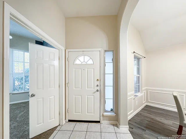 a view of a livingroom with wooden floor and stairs